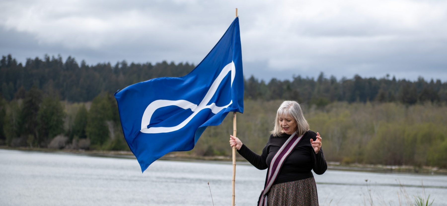 Elder Jo-Ina Young with Metis Flag